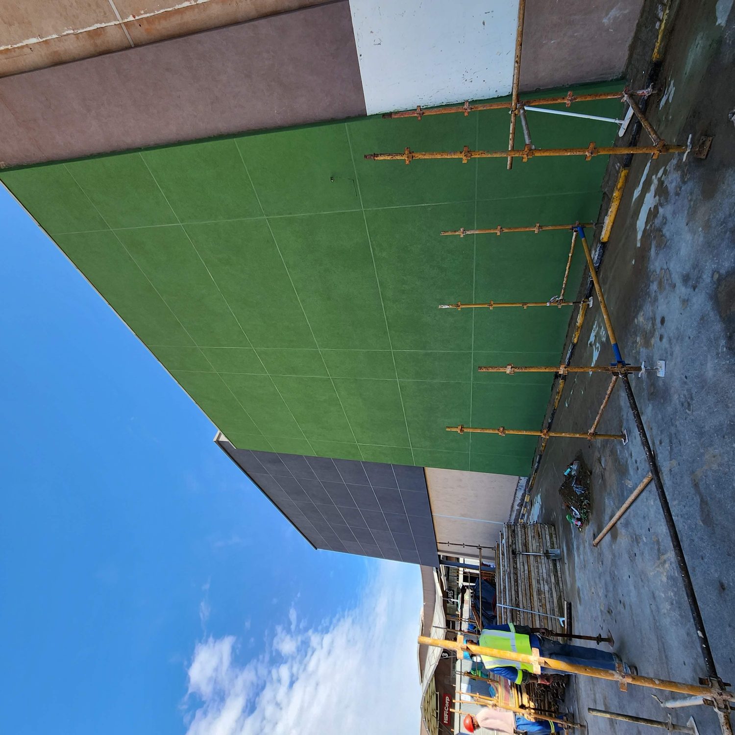 Charcoal, green and tan meeting on one continuous system. The colour change is a topcoat change only; the build-up behind all three is identical.