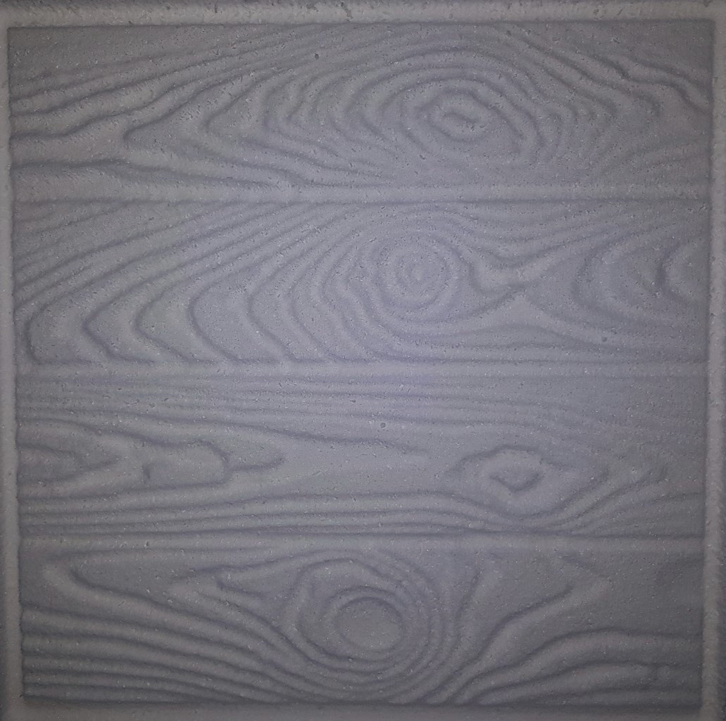 Close-up of an EPS panel with a plank-and-knot wood-grain texture milled into its face - fine grain lines, swirls and knots cut directly into the foam. The frame is filled by the panel, so there is no size reference in the shot.