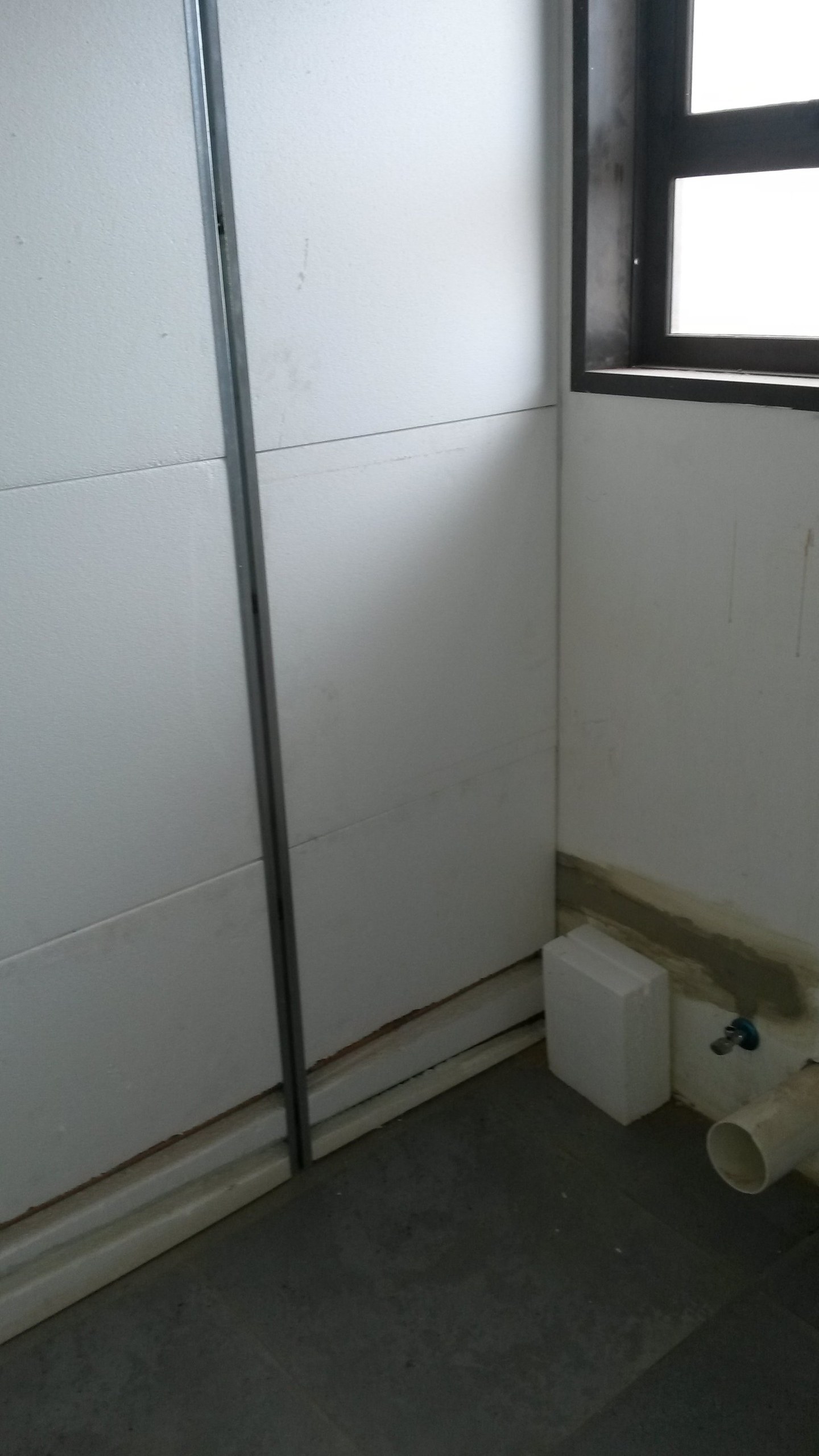 EPS panel-lined bathroom wall built around a cistern box, window fitted