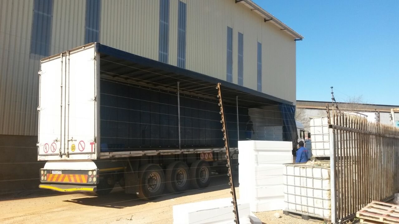EPS panels being loaded onto a truck outside the factory