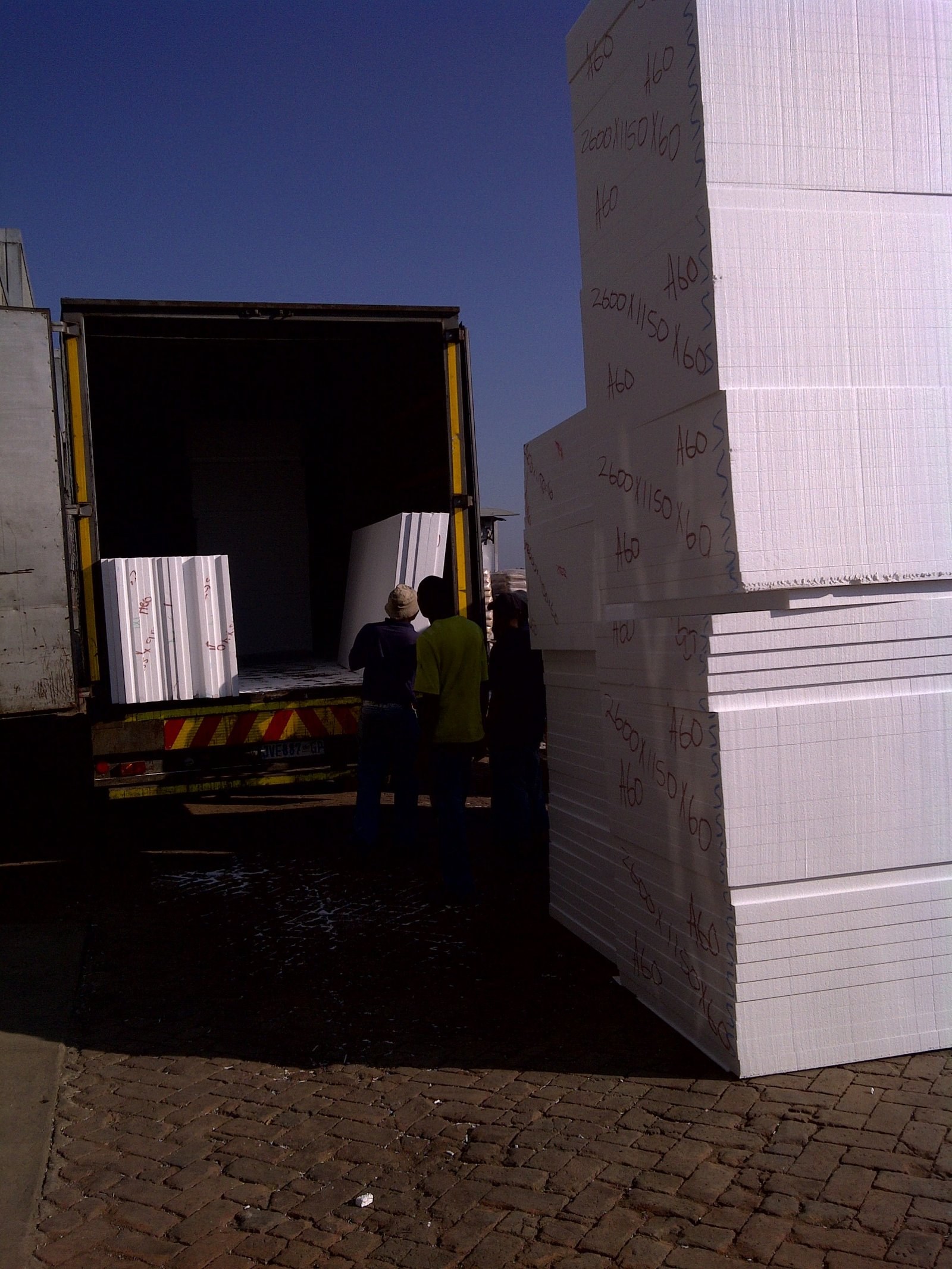 EPS board stack with size markings, loaded into a truck