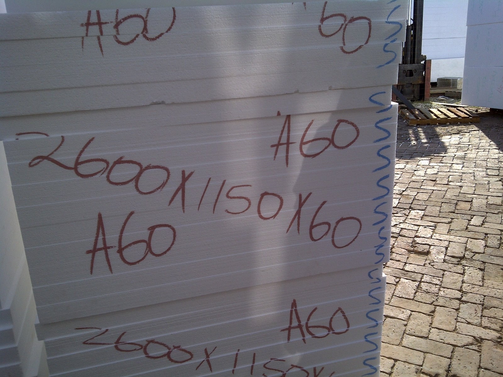 Close-up of handwritten size and grade markings on an EPS panel