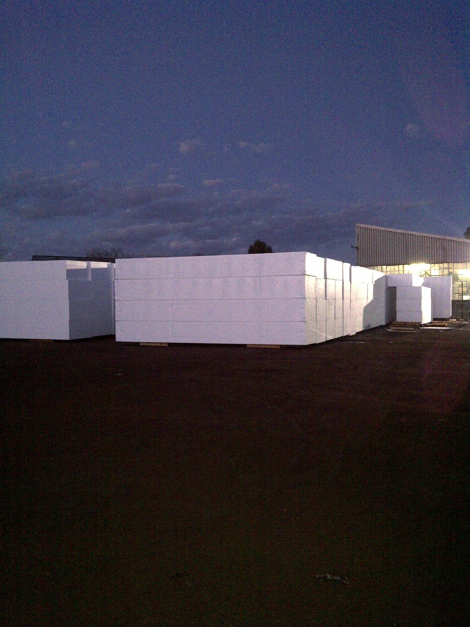 Corridor between stacked EPS block walls in the yard at dusk