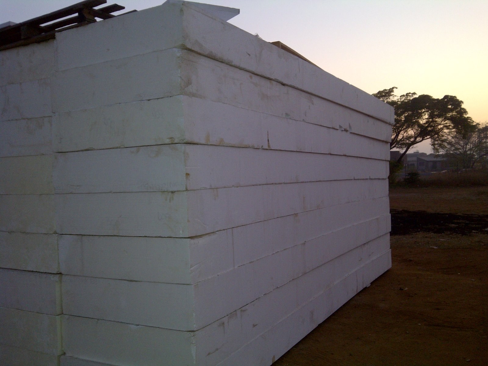 Corner of a stacked EPS block wall in the yard at dawn