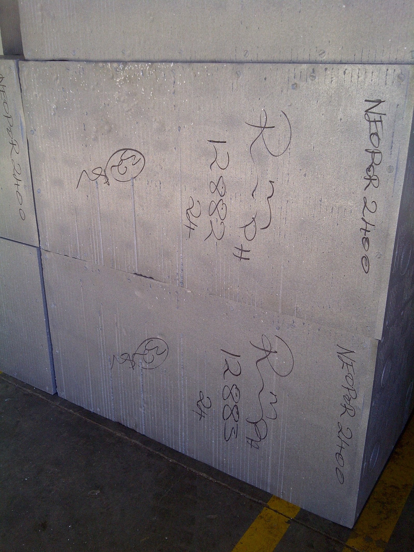Close-up of NEOPOR grade markings written on stacked EPS blocks