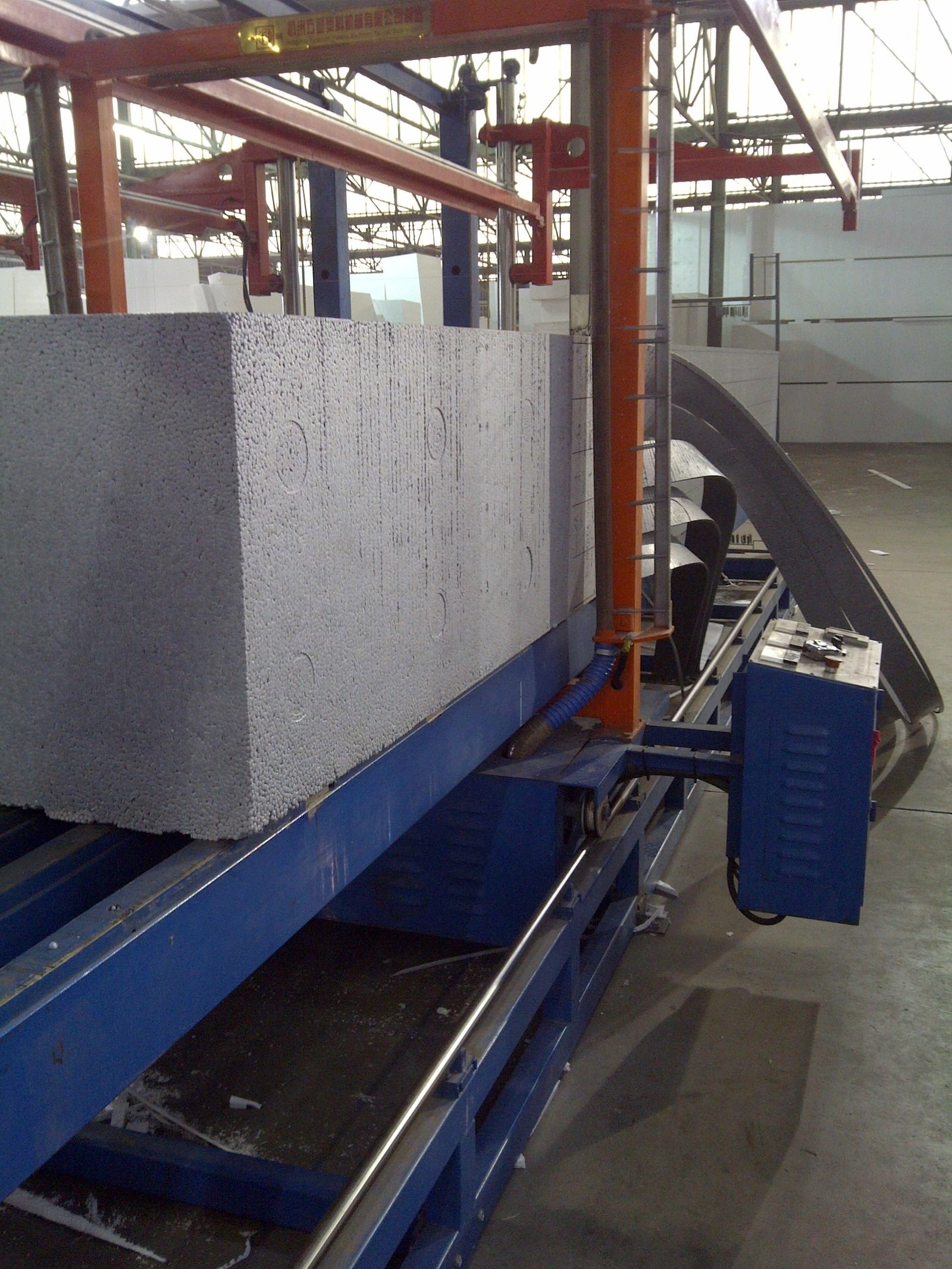 EPS block on the production line conveyor, overhead crane behind