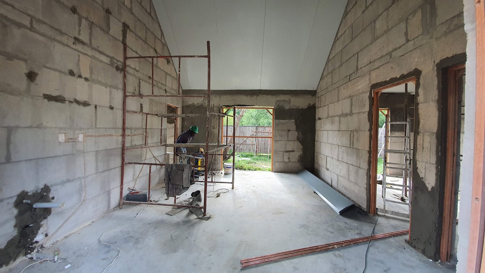 Interior of a vaulted-roof room with bare block walls, before plastering.