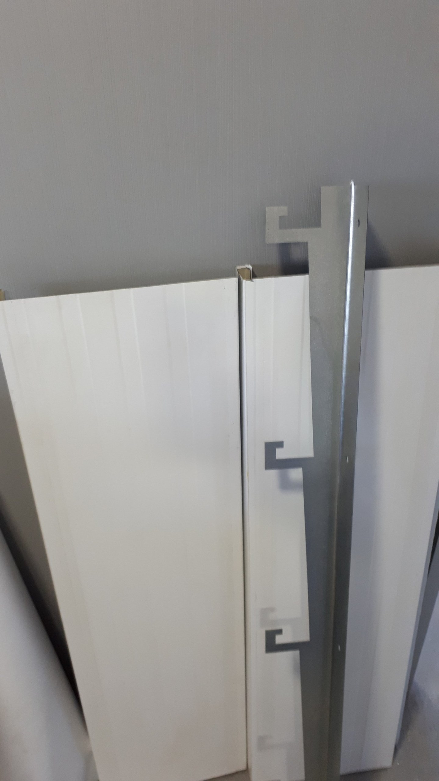 Close-up of a ceiling panel joint finished with a cover trim