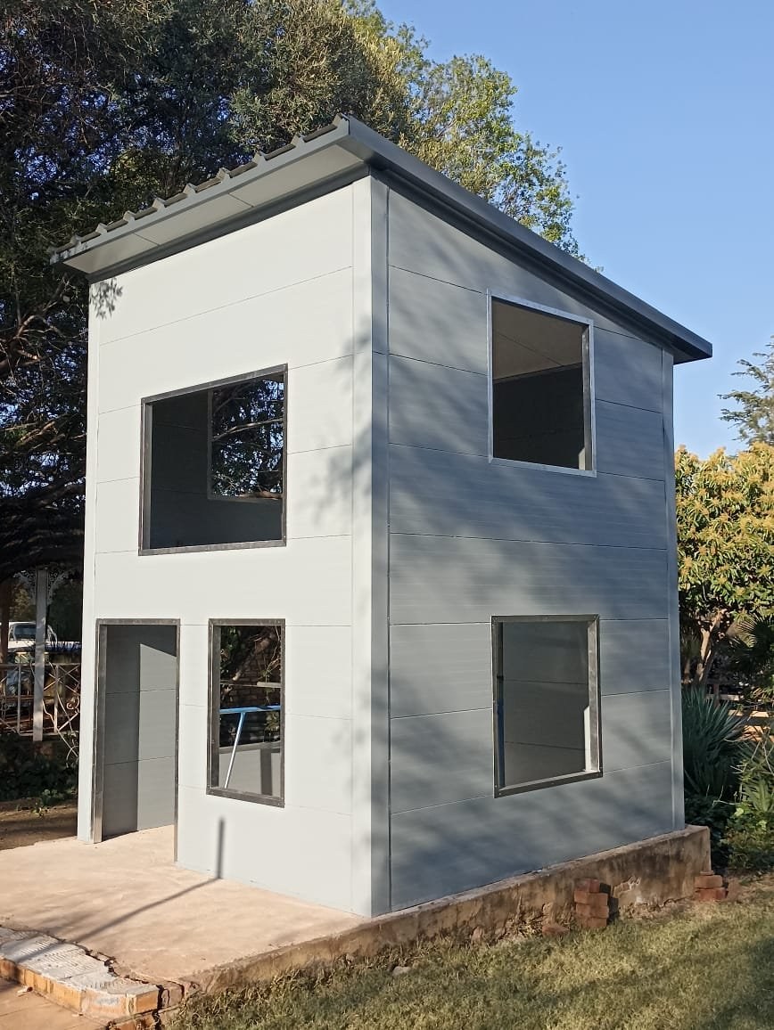 Completed small panel cottage standing in a garden setting