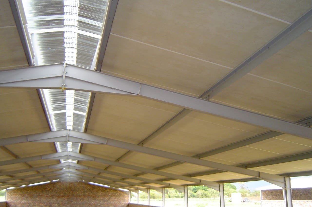 Roof apex and skylight joint on an insulated ceiling, brick gable wall below