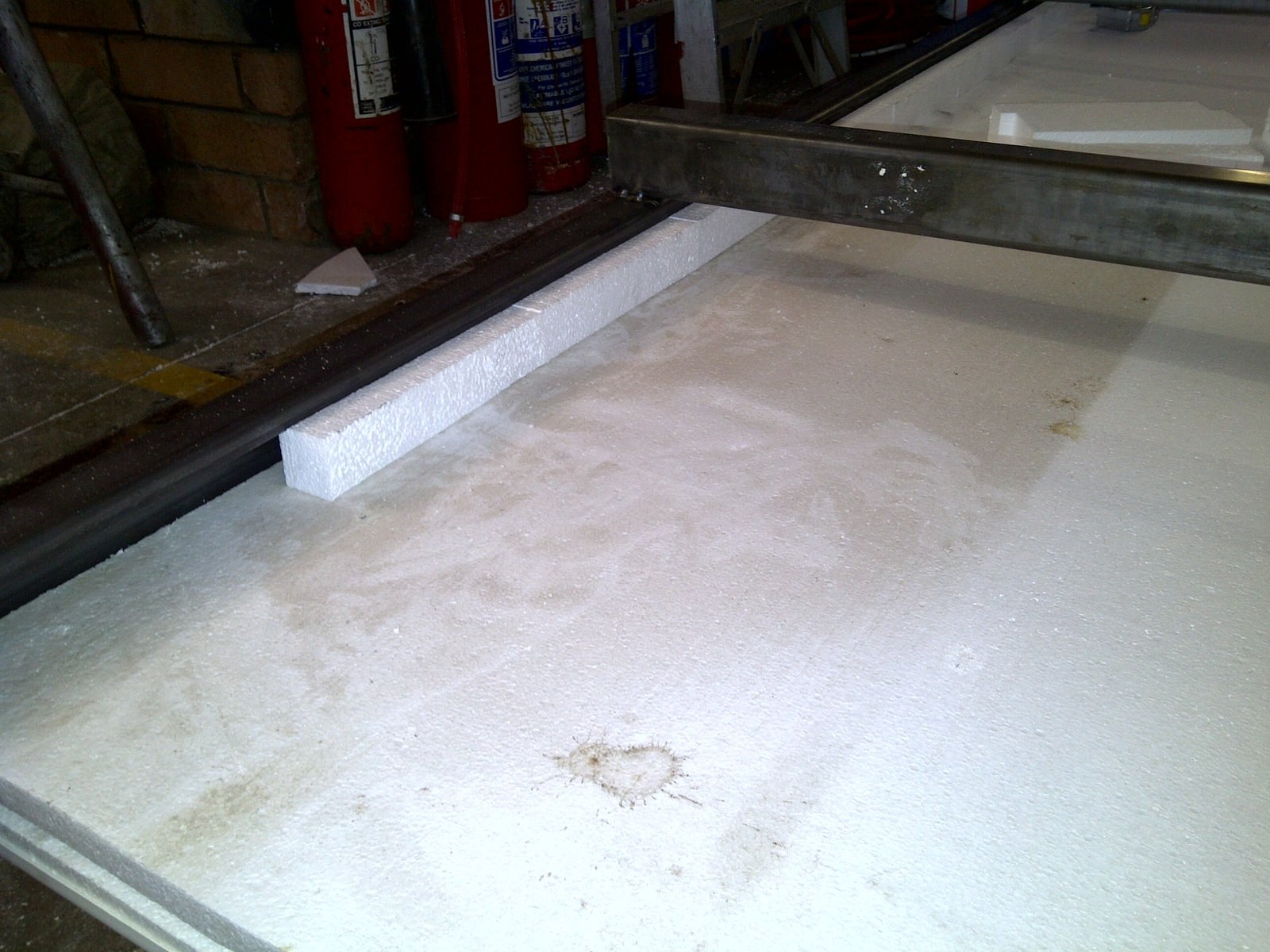 Worker finishing the edge of an EPS panel in the workshop