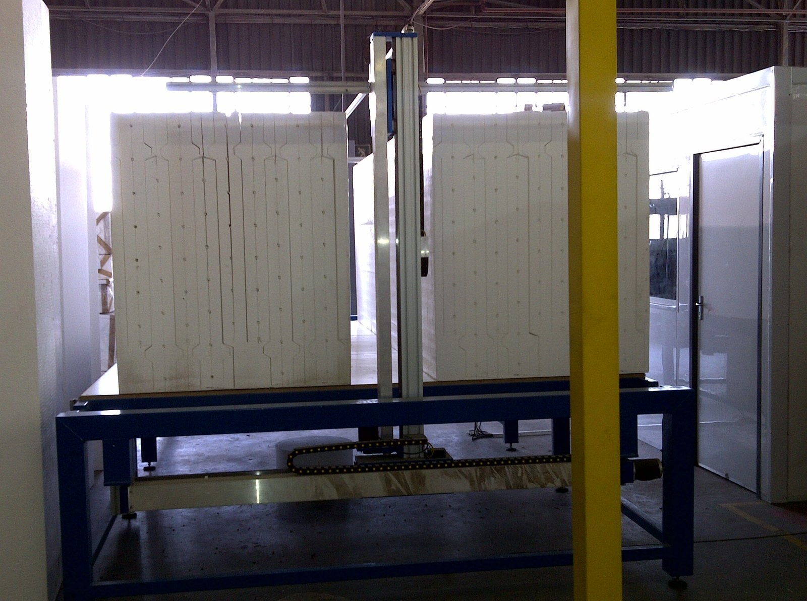 Large EPS core blocks with interlocking grooves cut, on a gantry rig in the factory