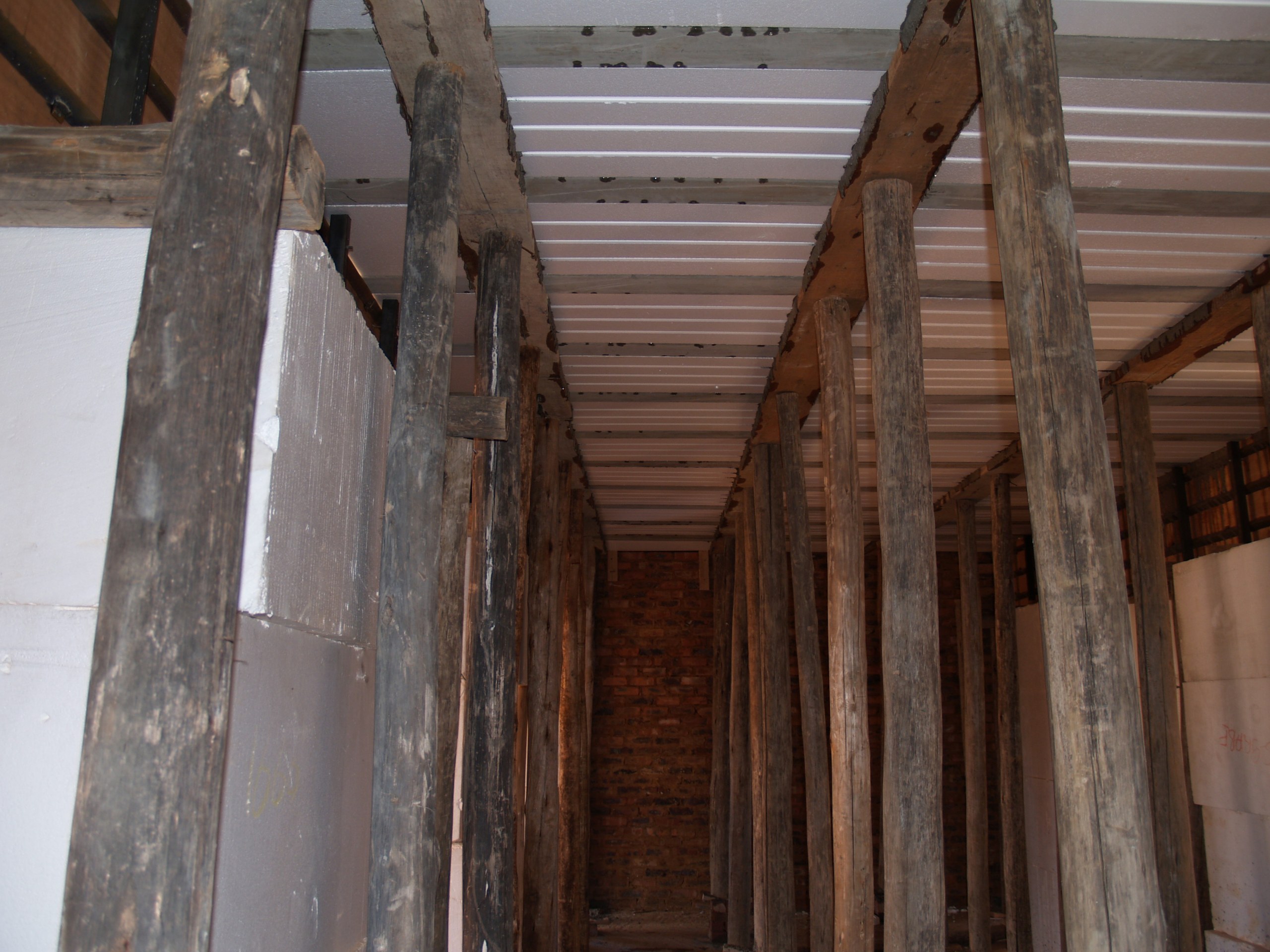 The same floor seen from underneath before the props come out: the white void formers span between the concrete ribs, which is what makes it a rib-and-block slab rather than a solid one.