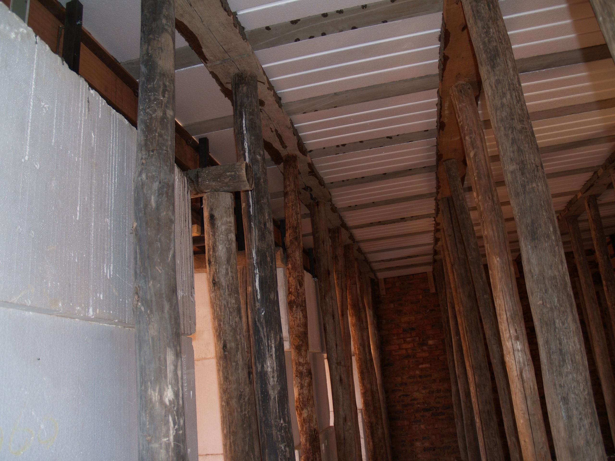 Void-former soffit and props from inside the storey below. The blocks stay in place permanently - they are formwork that is never stripped.